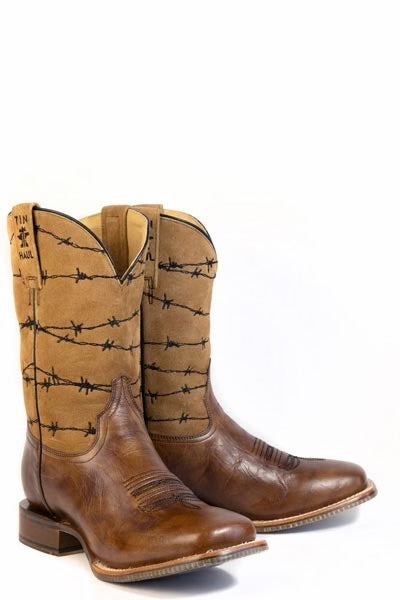 A pair of cowboy boots in brown leather and tan suede, featuring black barbed wire embroidery on the shafts, shown against a plain white background.