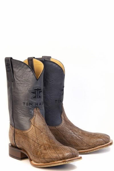 Pair of brown and black cowboy boots with 'Tin Haul' branding on a white background