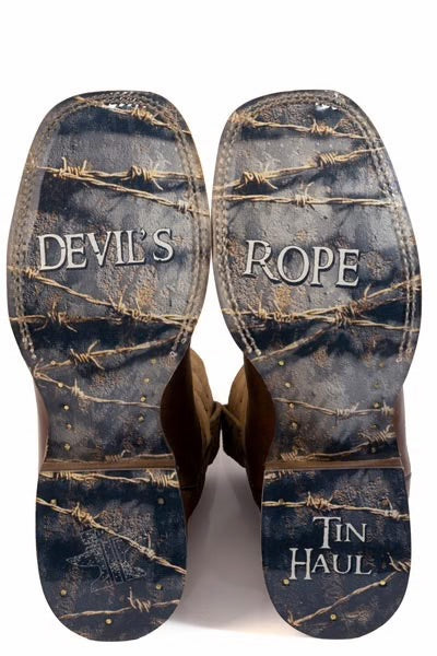 A pair of cowboy boots shown from the sole side, featuring a distressed dark blue and brown barbed wire camouflage pattern. The soles are says 'DEVIL'S ROPE' and 'TIN HAUL' in white text.
